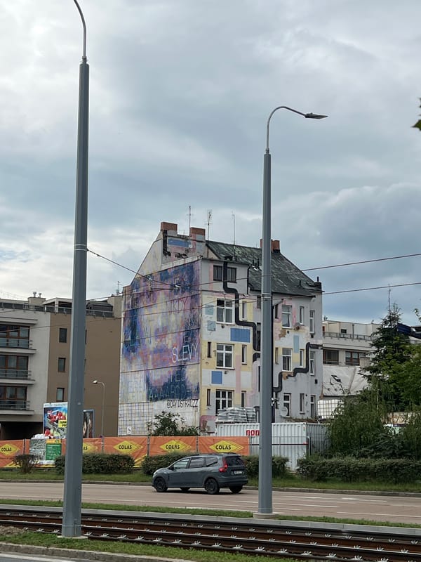 Street art and selfies around a Pilsen building mural