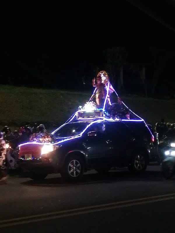 Decorated vehicle procession moves through Da Lat Vietnam streets