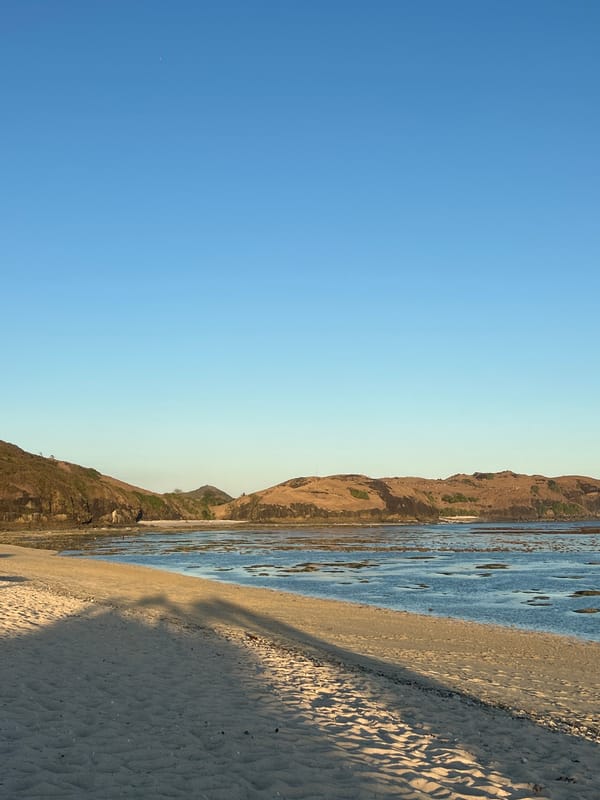 Kuta Beach at golden hour, bars and shoreline