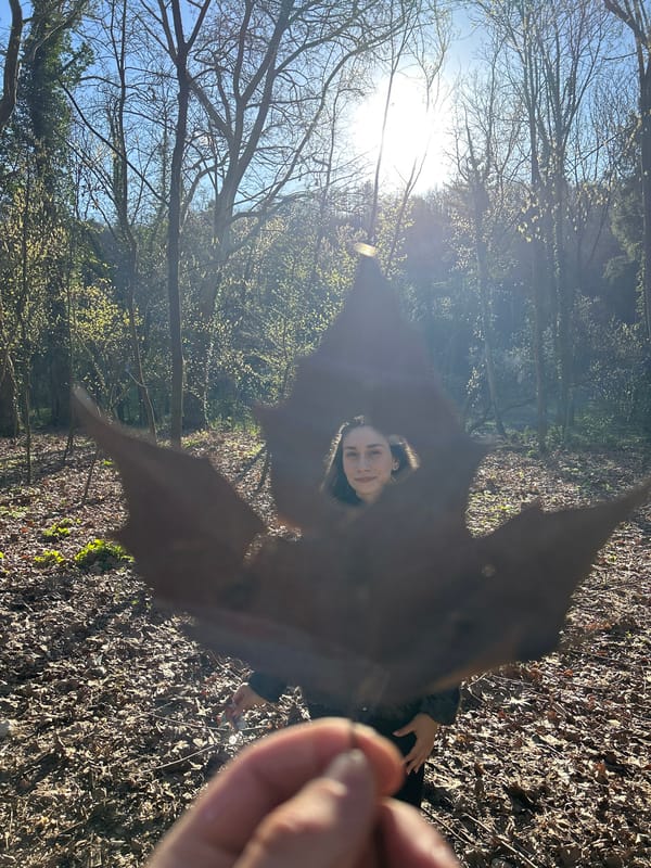 Woman photographed with leaf in wooded area, Pleven