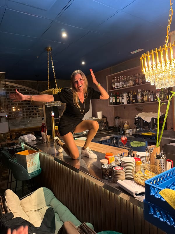 Woman stands on bar counter in Salou nightlife district