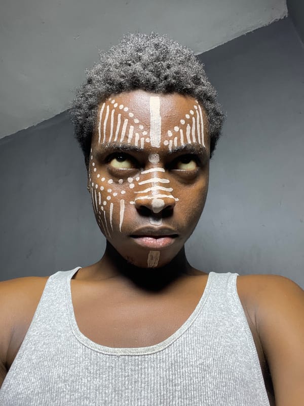 Person displays traditional white face paint in Nkpor, Nigeria