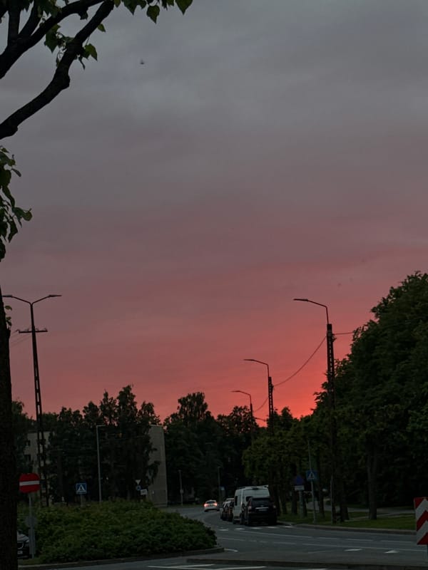 Tallinn streets glow under a vivid pink-orange sunset