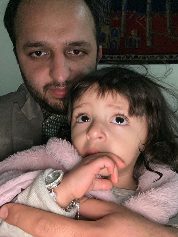 Father and child share tender moment in Kandahar