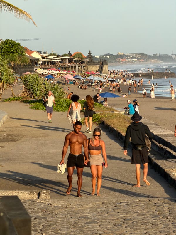 Sunset crowd gathers on Echo Beach rocks in Canggu