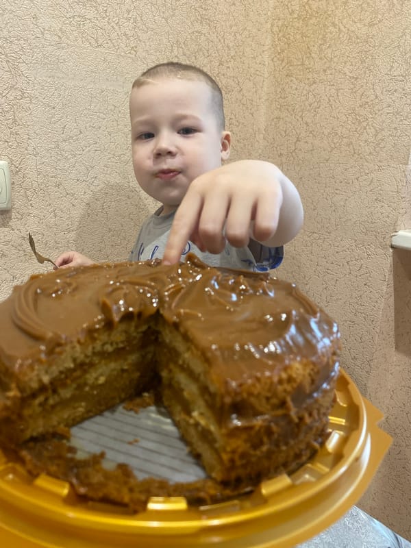 Child enjoys cake and playtime in Sochi home
