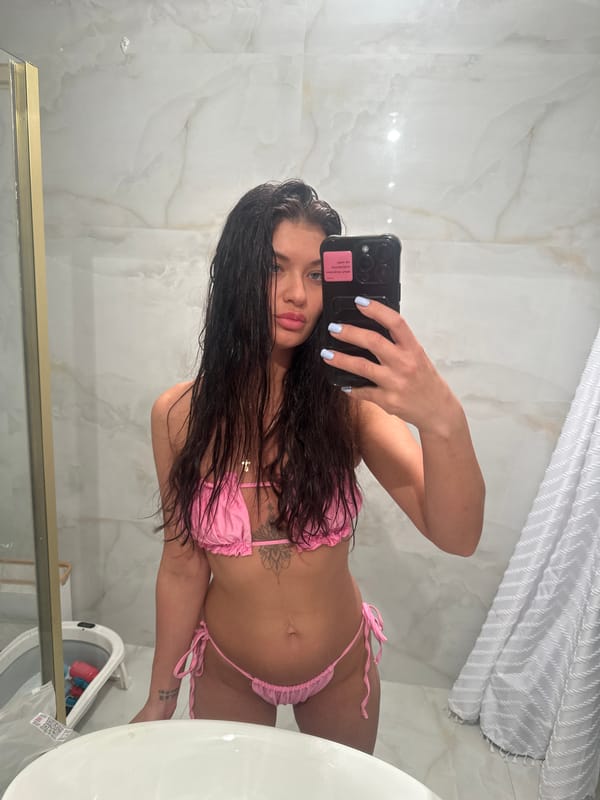 Woman takes bathroom selfie in pink bikini, Moscow