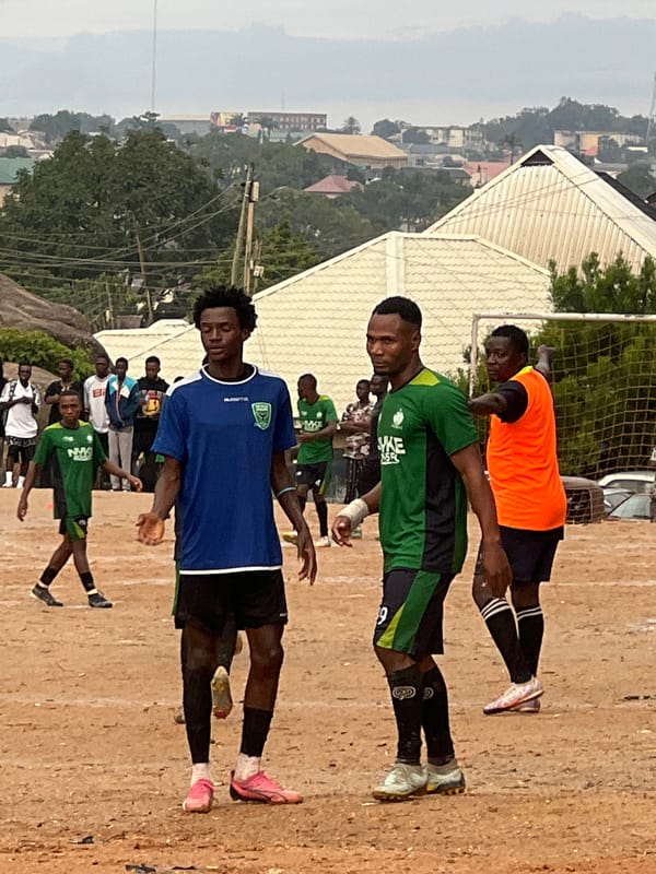 Pickup football on a Jos dirt pitch among rocky terrain