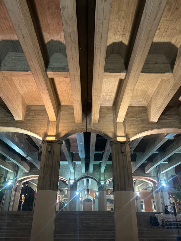 Bilbao riverfront at night, featuring a rainbow tunnel installation