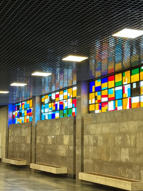 Inside New Athos: station platforms, ornate interiors, resting dog