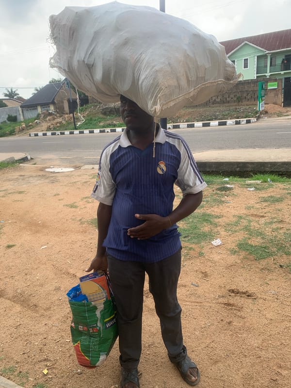 Everyday street activity across a Jos neighborhood midday