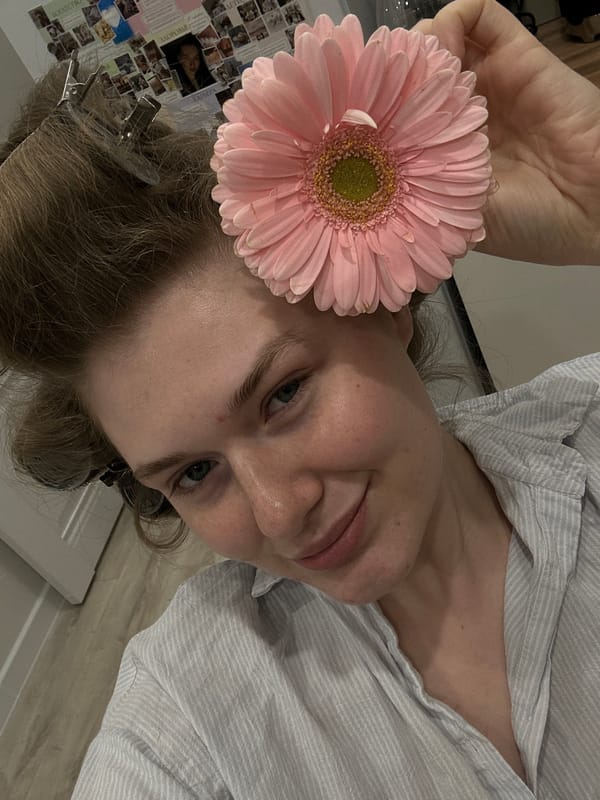 Woman poses with pink gerbera daisy in Kazan