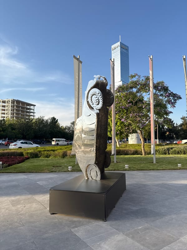 Car sculpture and vintage portraits observed in Puebla plaza