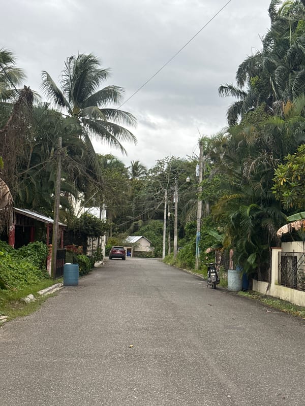 Street scene captured in Cabarete with red SUV