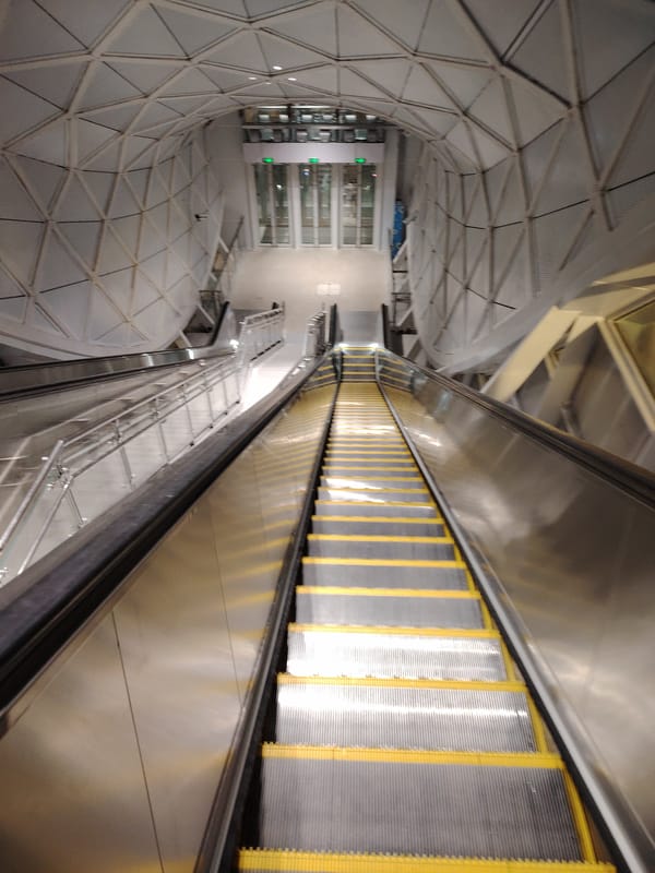 Moving through a bright, modern indoor transit or shopping space