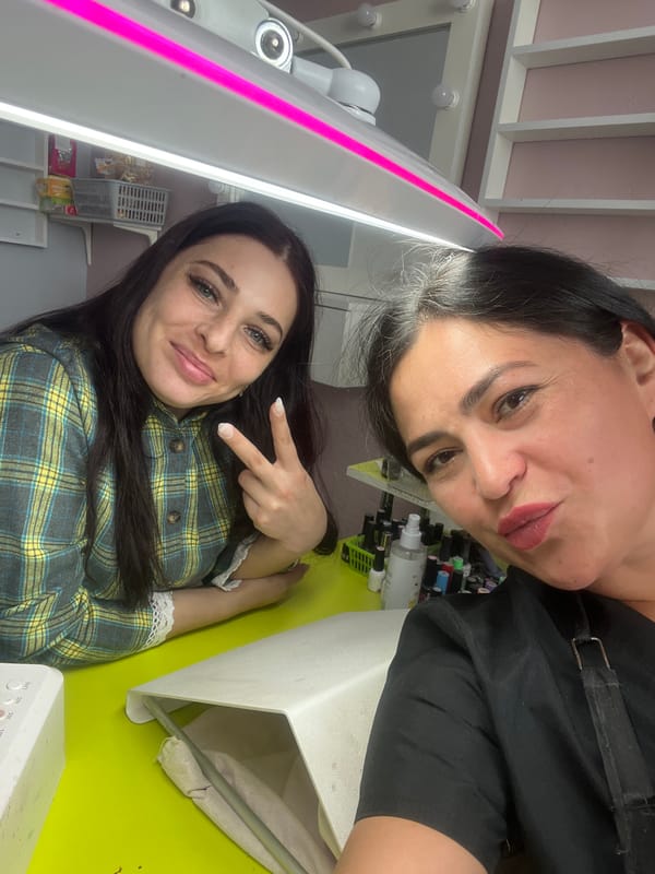 Women pose playfully at beauty salon in Chaikovsky
