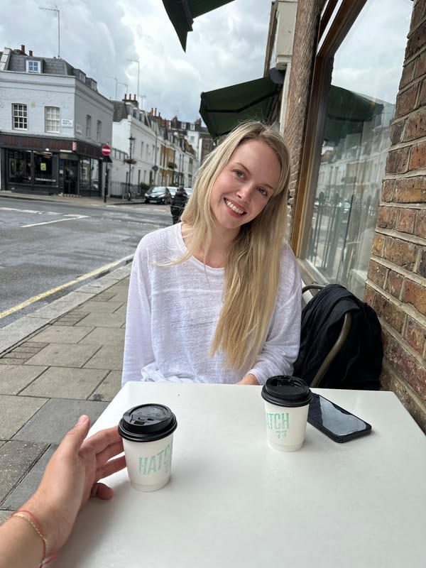Woman enjoys coffee at London outdoor cafe
