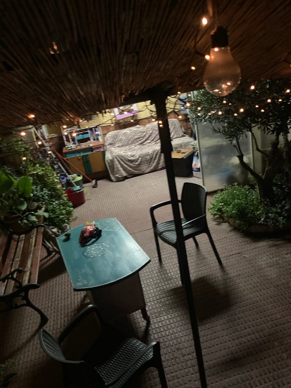 Warm-lit thatched patio bar at night in Sabadell
