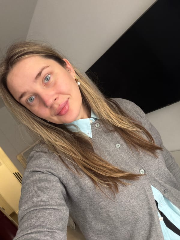 Woman in light blue shirt observed resting indoors Moscow