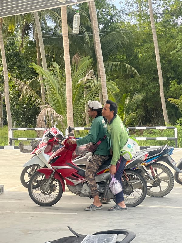 Motorcycles, locals, and street activity in Ko Pha-ngan