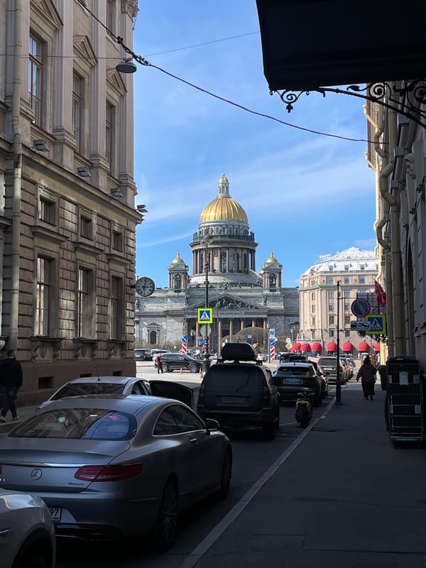 Tourist poses for photos near St. Isaac's Cathedral, Saint Petersburg