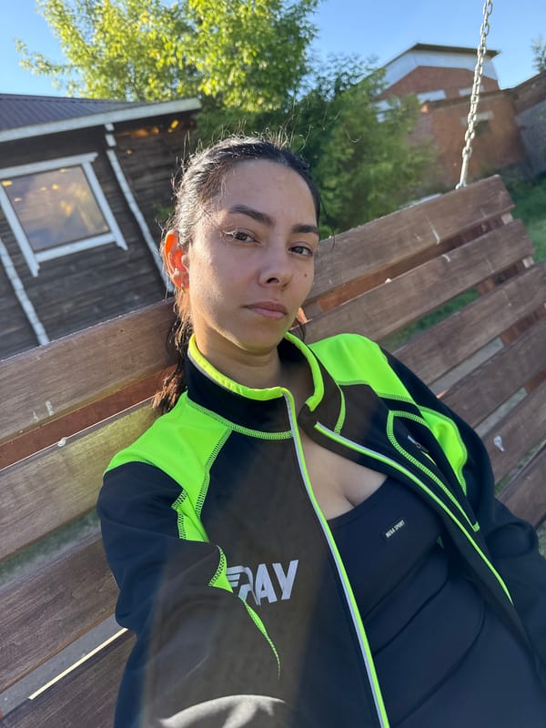 Woman in athletic wear sits outdoors in Chaikovsky