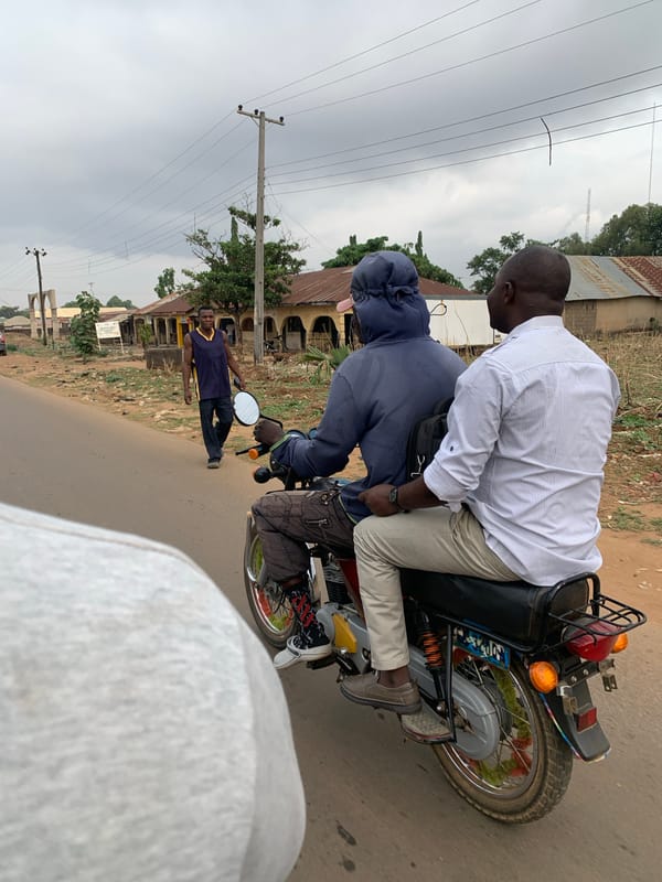 Motorcycle riders traverse dirt roads in Maigizo, Nigeria