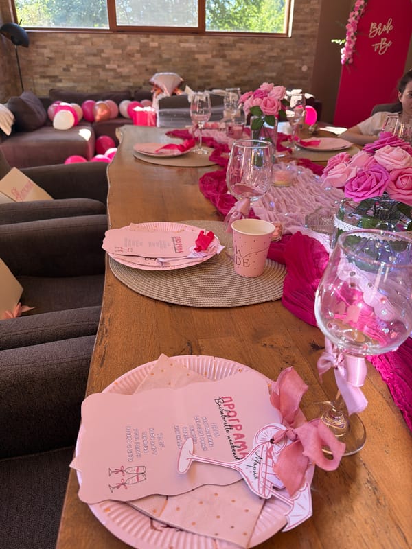 Bachelorette party table set with pink decorations and flowers