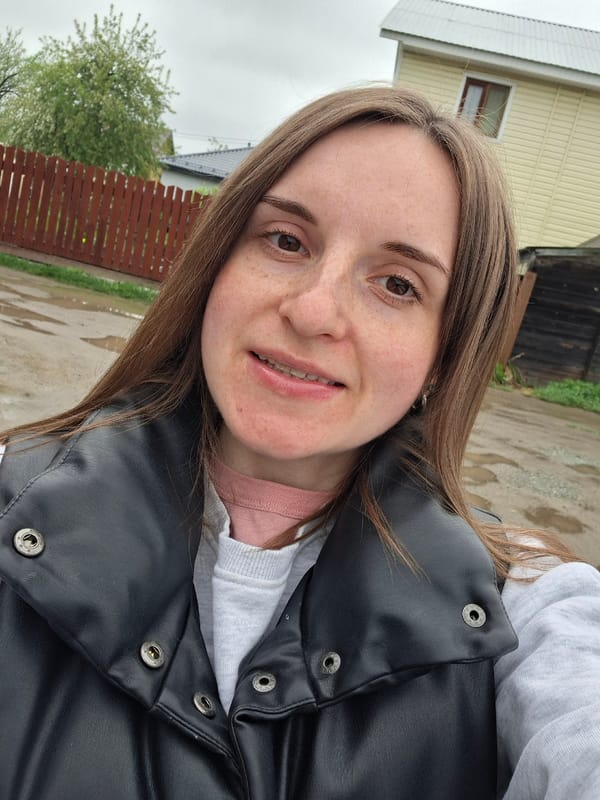 Woman takes outdoor selfie in casual winter clothing