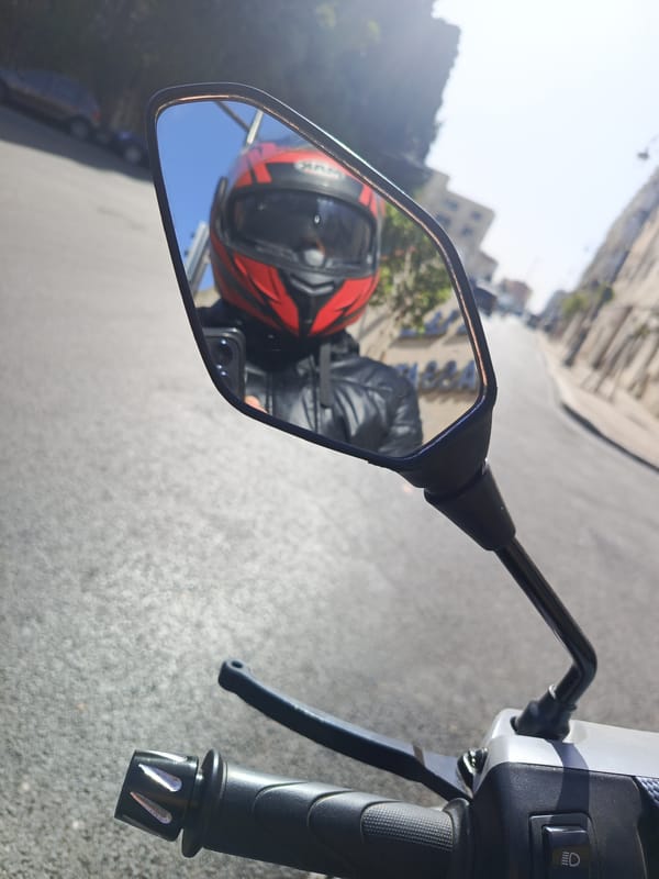 Motorcyclist rides through sunny Meknes streets, Morocco