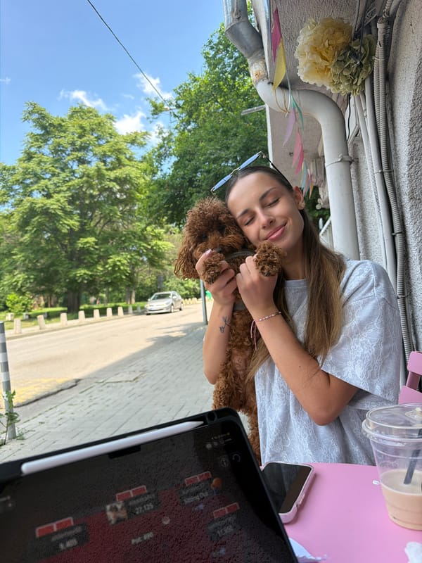 Woman plays with curly dog on Sofia streets