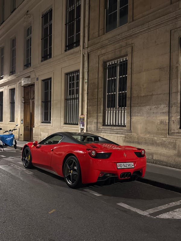 Red Ferrari spotted parked on Paris street at night