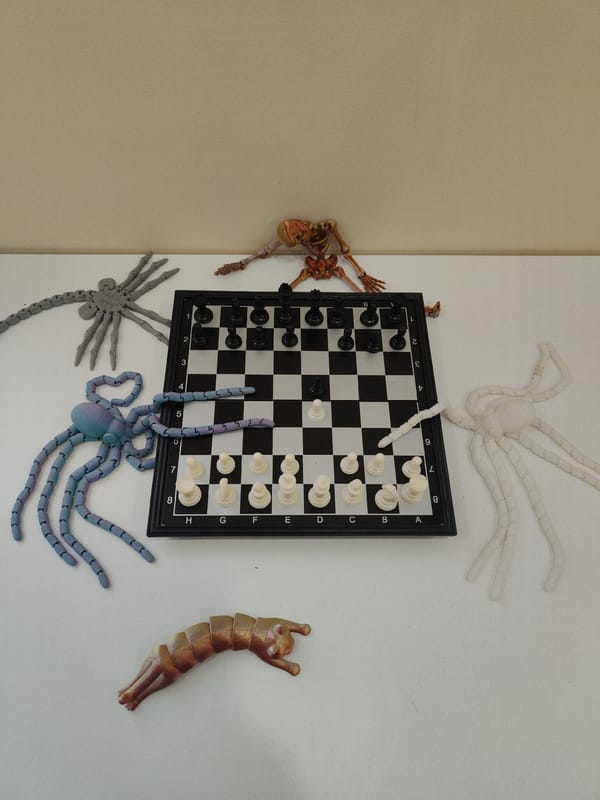 Chess board surrounded by toy creatures captured in studio