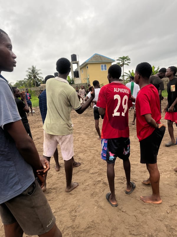 Soccer match on dirt field in Badagry, Nigeria