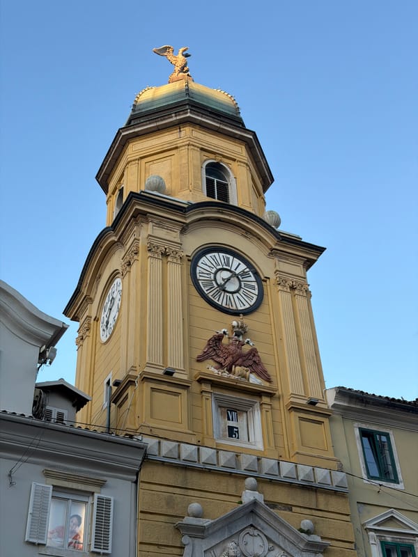 Tourist photographs historic Rijeka City Tower and architecture