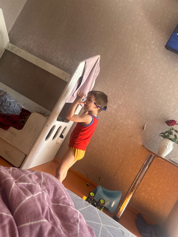 Young child plays on furniture in Omsk home