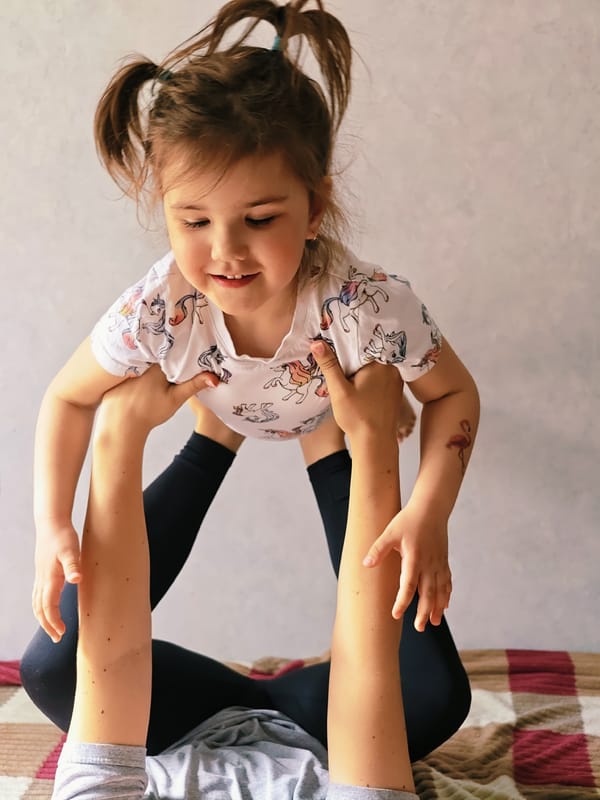 Woman and child share quiet morning moment on blanket