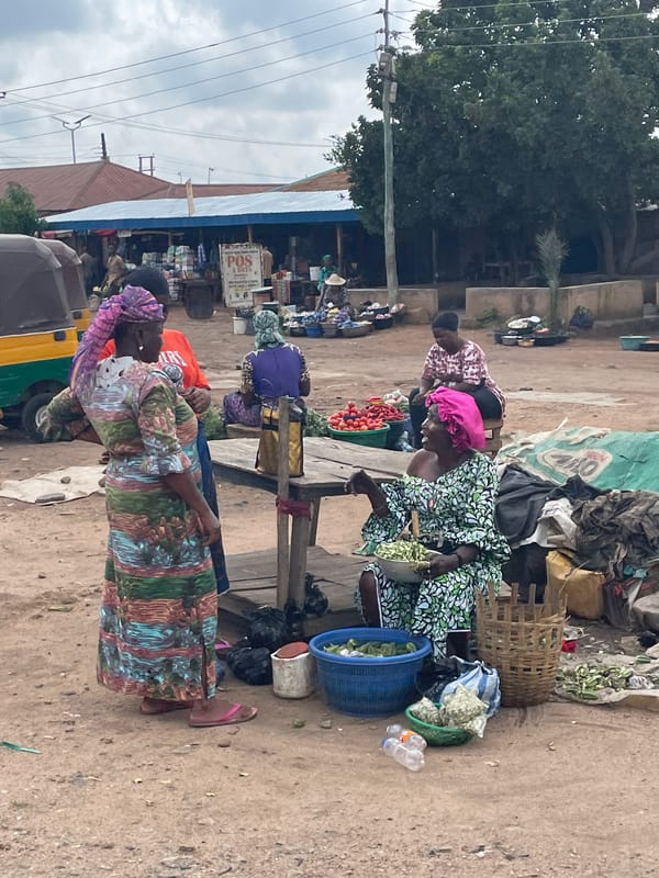 Street market activity in Bukuru, Nigeria on a cloudy morning