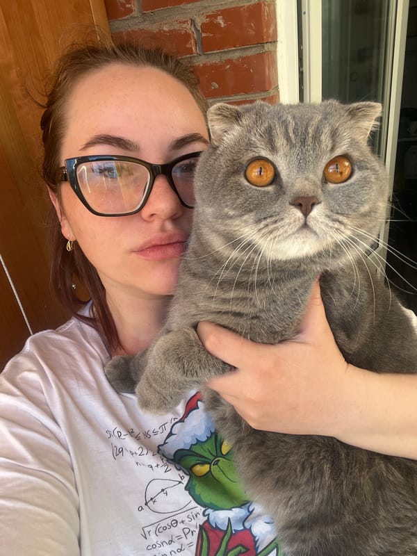 Woman photographed with grey cat in Chaikovsky, Russia