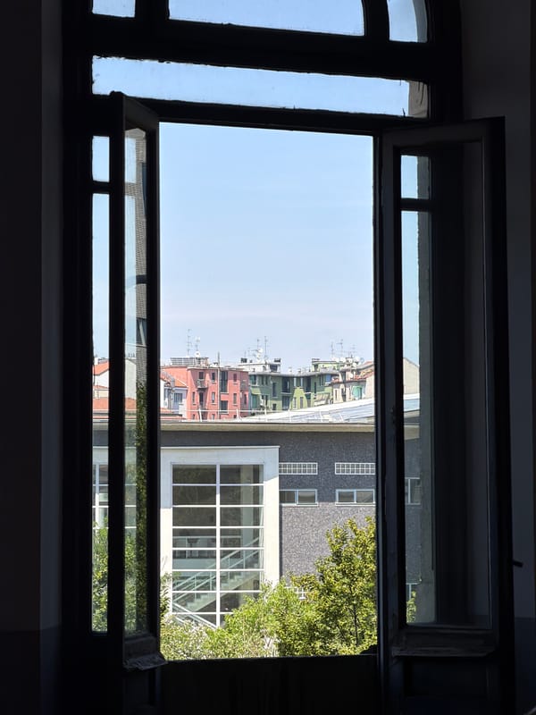 Milan afternoon: window views, rooftops, and fresh cherries