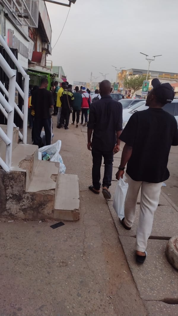 Two men in black shirts walk Jos sidewalk