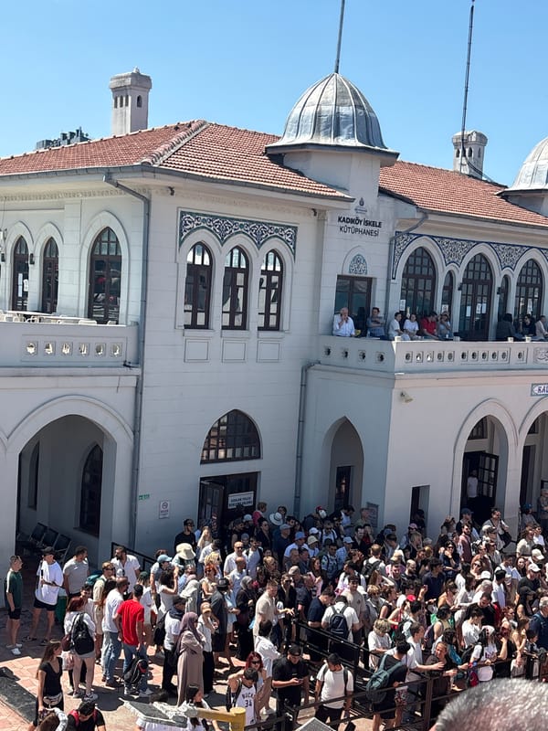 Morning crowd gathers at Kadıköy ferry station on sunny day