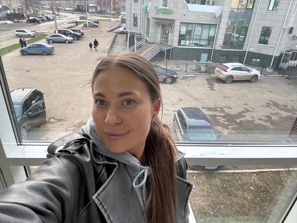 Woman observed at window in Chernushka, Russia