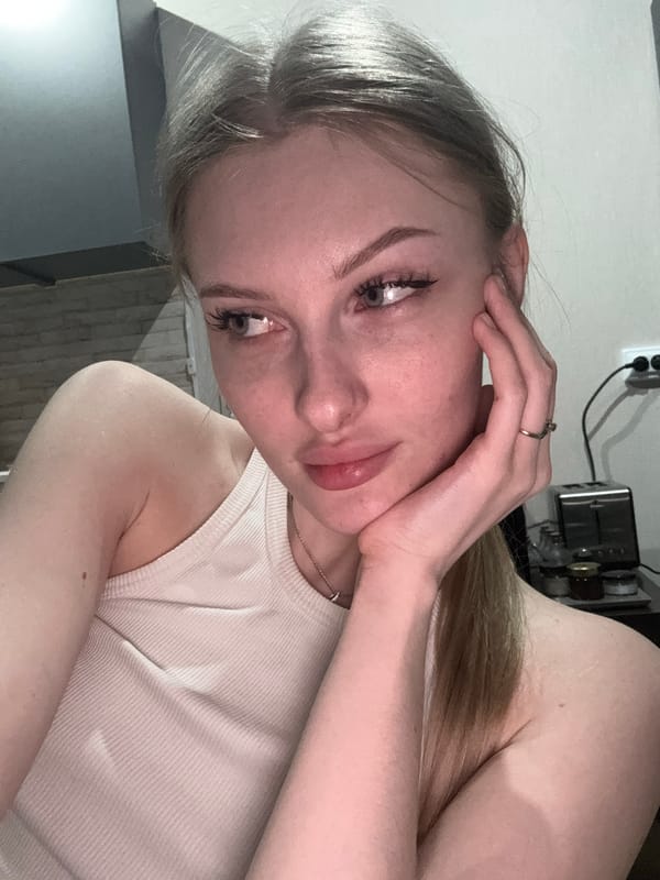 Woman takes playful selfies on couch in Perm