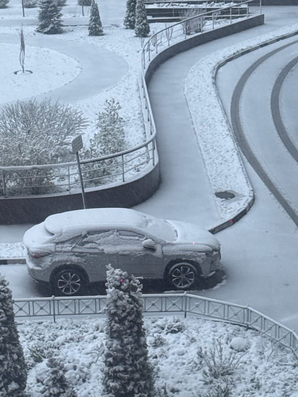 Heavy spring snowfall blankets Khimki, Russia streets and buildings