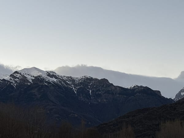 Snow-covered Pyrenees mountains photographed under gray skies in Spain