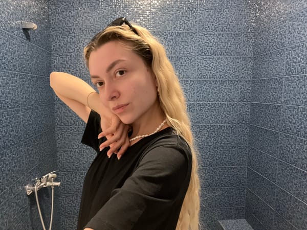 Young woman takes bathroom mirror selfies in morning session