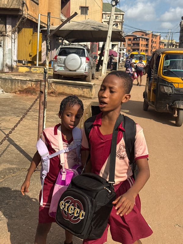 Schoolchildren and street life on a busy Onitsha afternoon