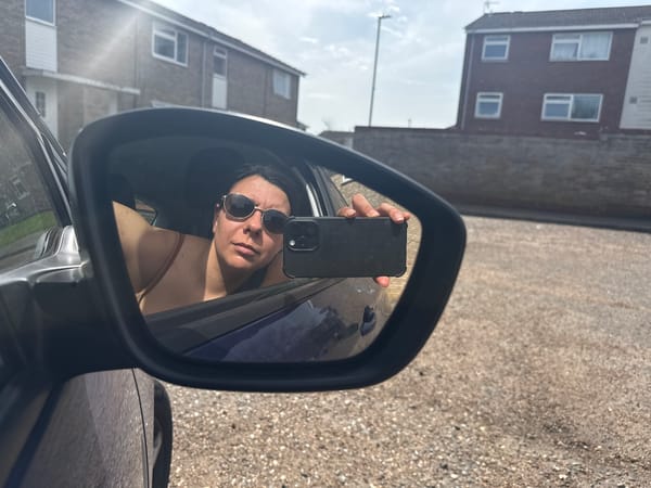 Woman Takes Selfie in Car Mirror on Gorleston Street