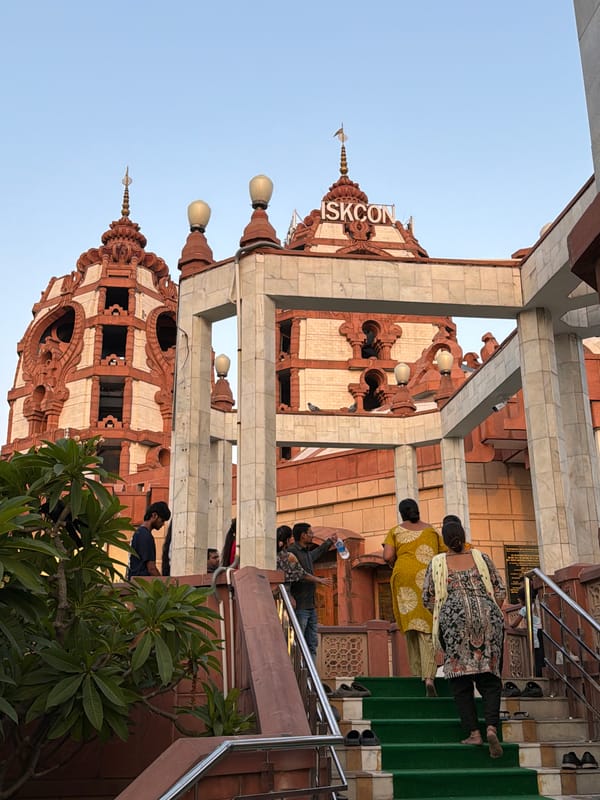 Inside and outside Delhi's ISKCON Temple on a busy afternoon